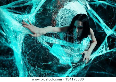 Woman sitting in big cocoon. Creative photoshoot