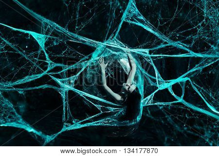 Girl like a spider getting out from the cocoon
