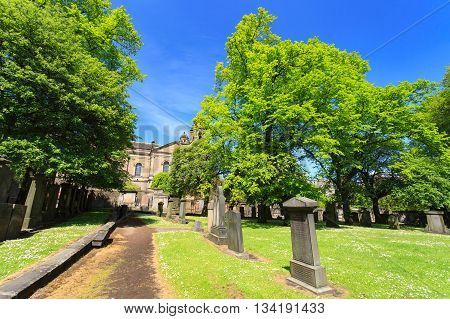 EDINBURGH - MAY 29 2016: Gravestones at The Parish Church of St Cuthbert on sunny day. This church is one of the famous churches in Edinburgh May 29 2016 in Edinburgh UK