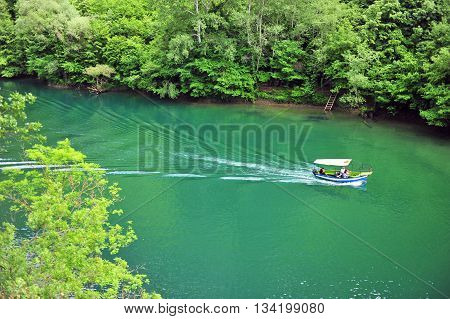 Speed boat goes by the river in Matka canyon Macedonia