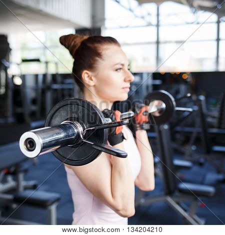 Young Beautiful Woman Training Biceps With Barbell