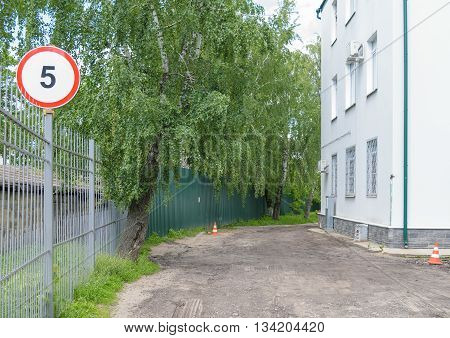 Road sign limiting the maximum speed of movement of vehicles 5 km per hour at the entrance to the courtyard