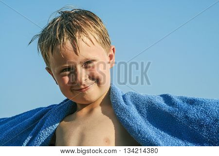 cute smiling child with towl at the beach