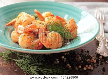 Shrimps with fresh herbs on a plate