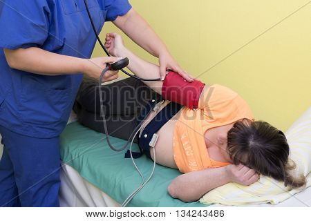 Cardiotocography (CTG) pregnant woman in clinic, doctor obstetrician