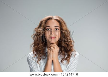 The Woman is looking imploring over gray background