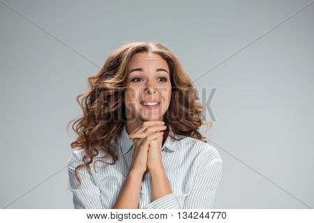 The Woman is looking imploring over gray background