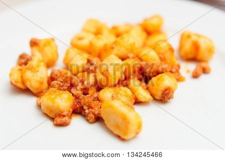 Italian gnocci potato dumplings with meat ragout close-up