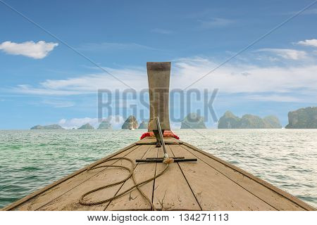 Traditional Thai wooden longtail boat heads out into the Andaman Sea on a day trip.