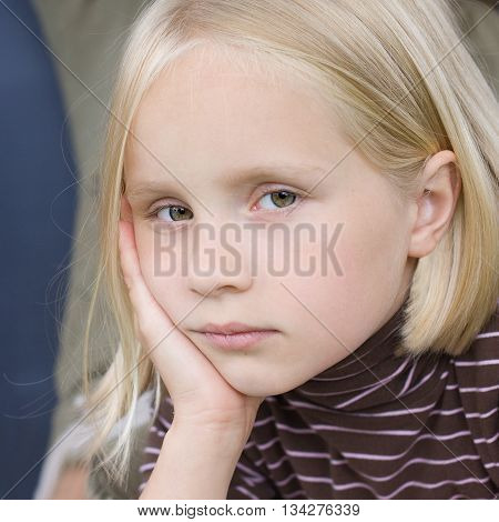Sad blonde teen girl - face close-up.