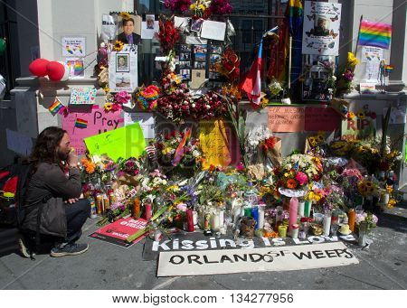 San Francisco, CA 6/13/16 Man pays respects at an impromptu memorial on Castro Street in San Francisco to the shooting victims in Orlando, FL.