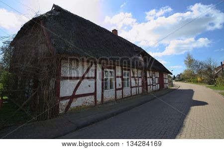 WEITENHAGEN GERMANY - APRIL 20 2016 : Facade of a historic house with reed roof.