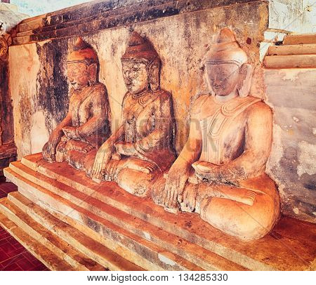 Three Buddha statues at Takhaung Mwetaw pagoda in Sankar. Myanmar. 
