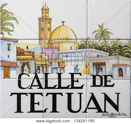 MADRID. SPAIN - MARCH 13. 2016 : Closeup of the street sign. Street signs in Madrid are hand-painted ceramic tiles typically composed within 9 or 12 tiles. They depict the name of the alley or street.