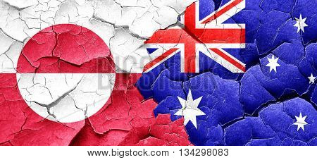 greenland flag with Australia flag on a grunge cracked wall