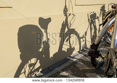 Shadow of bike on a wall. Transportation in the city.