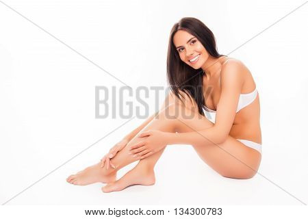 Pretty Woman In White Underwear Doing Massage For Her Legs