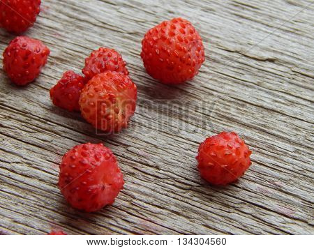 Ripe and juicy strawberries on wooden table