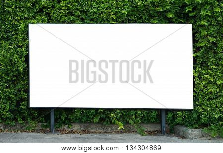 Empty billboard White billboard on spring summer green leaves background Blank billboard mockup template for advertisement present