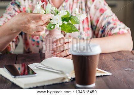 Coffee To Go. White Flowers On The Rustic Background.