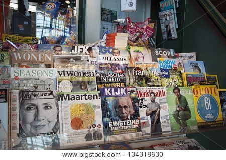 Several colored magazines, displayed in a book kiosk