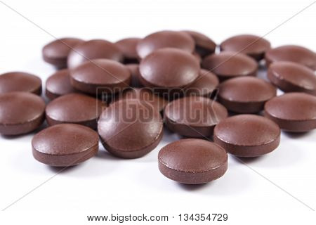 Brown Medical Tablets And Capsules On White Background, Health Care Concept