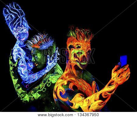 Fire, Body art glowing in ultraviolet light, isolated on black background. Land Loves Air