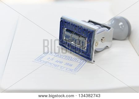 Date - Rubber stamp is stamping on the white paper