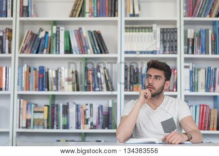 Student reading book in school library. Study lessons for exam. Hard worker and persistance concept.