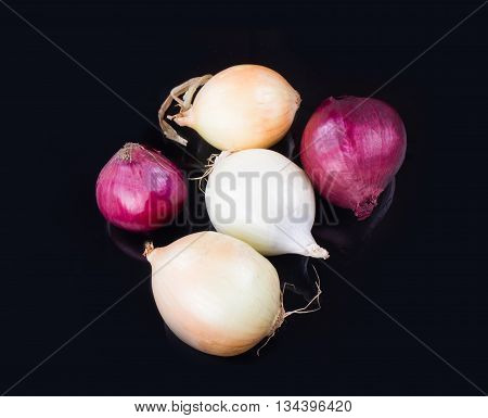 Some Onions On A Black Background