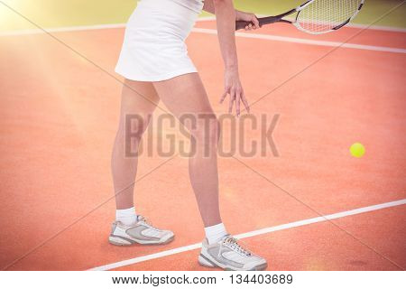 Athlete playing tennis with a racket against composite image of tennis field