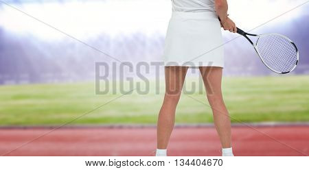 Athlete playing tennis with a racket against race track