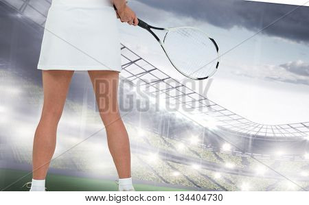 Athlete playing tennis with a racket against sports arena