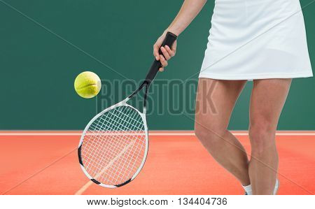 Athlete playing tennis with a racket against digitally generated image of playing field