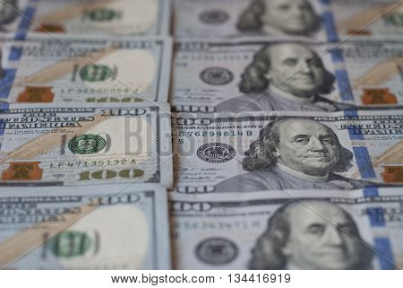 New hundred dollar bills, rows of aligned banknotes closeup