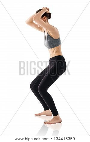 Sporty beautiful young woman practicing Uddiyana Bandha technique isolated on white