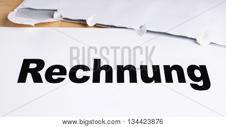 Rechnung german invoice letter with opened envelope on desk