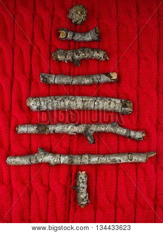 Christmas warm knitted background with new year tree decorations made of sticks. Vintage christmas card with handmade christmas tree. X-mass concept.