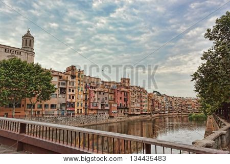GIRONA SPAIN - JULY 17 2013: Onyar River in Girona. It divides the city into two parts: on the left bank is the historical center on the right - the usual modern Catalan city