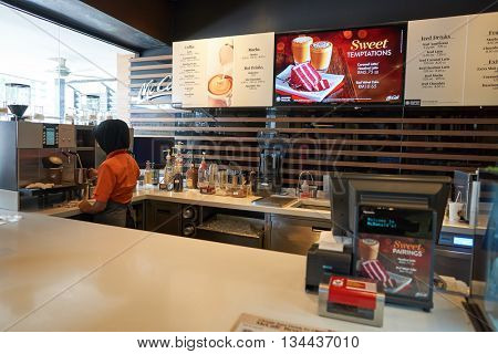 KUALA LUMPUR, MALAYSIA - MAY 09, 2016: barista preparing coffee in McCafe. McCafe is a coffee house style food and drink chain, owned by McDonald's.