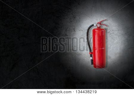red Fire Extinguisher on concrete wall with  black vignette border