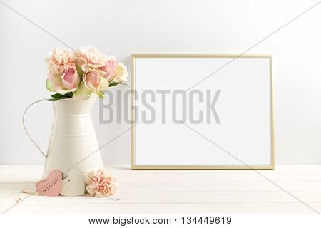 Mockup styled stock photograph of cream jug of flowers next to a Gold frame. You can place your business promotion blog title quote headline or image in the frame.