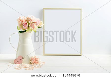 Mockup styled stock photograph of cream jug of flowers next to a Gold frame. You can place your business promotion blog title quote headline or image in the frame.