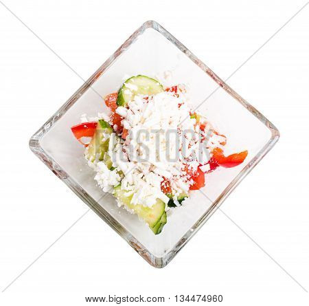 Traditional bulgarian salad shopski with fresh vegetables and grated sheep cheese. Isolated on a white background.