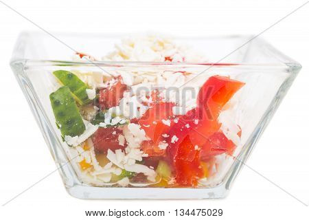 Traditional bulgarian salad shopski with fresh vegetables and grated sheep cheese. Isolated on a white background.
