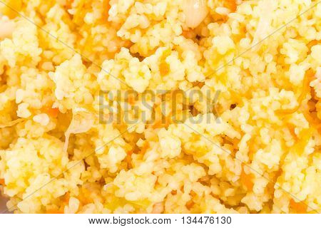 Delicious ocuscous porridge with tomatoes and onions. Macro. Photo can be used as a whole background.