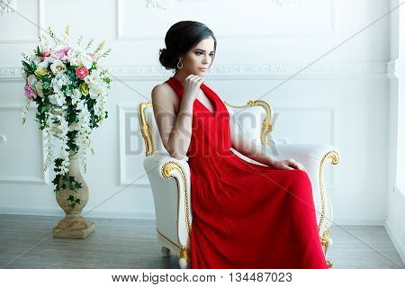 Portrait of Beautiful Sensual smilyng Woman in Fashion Red Dress. Christmas Sales and Shopping concept. Studio shot