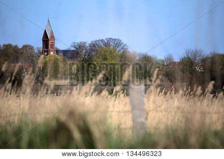 Bugenhagen Church In Greifswald-wieck, Germany With Selective Focus And Blue Sky
