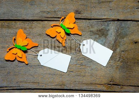 Colorful Felty Butterflies With Empty Signs On Wooden Table
