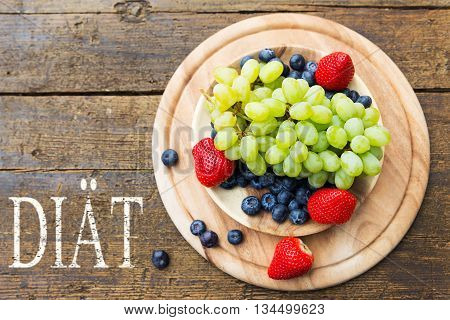 Flat Lay, Fresh Mix Of Seasonal Fruits On Wooden Table, German Word